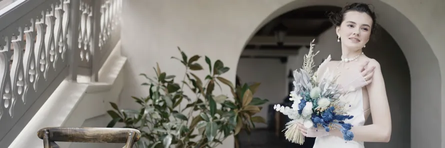 A luxury Mercedes S Class wedding car decorated with ribbons arriving at Bredenbury Court Barns for a bridal party.