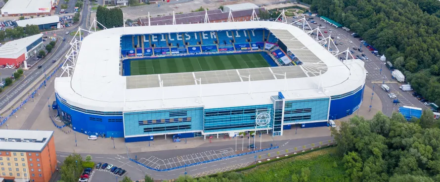 A luxury Manner Borne chauffeur car parked outside King Power Stadium, providing executive matchday transport for Leicester City fans.