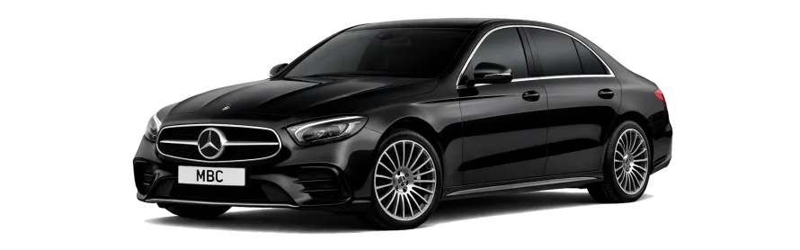 An executive relocation chauffeur greeting a client at Manchester Airport, facilitating smooth transitions into the North West with luxury luggage handling.