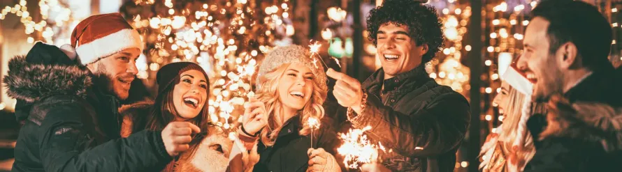 A luxury Mercedes-Benz S-Class chauffeur car parked outside a festive venue for a New Years Eve Party in Manchester, providing executive event transport.