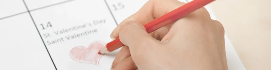 A luxury black Mercedes-Benz S-Class chauffeur car parked outside a romantic restaurant for a special Valentine's Day date in Manchester.