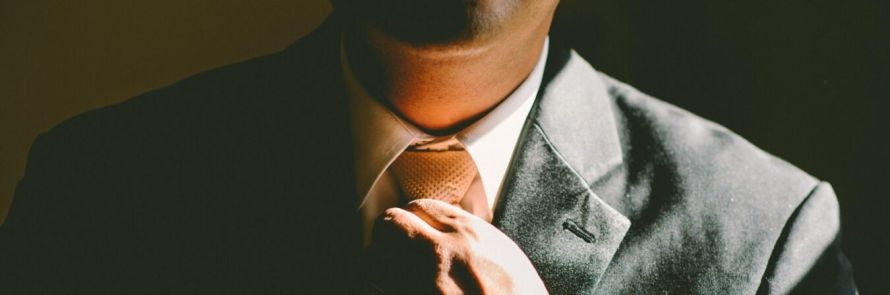 A professional corporate roadshow chauffeur UK driver assisting an executive into a luxury Mercedes-Benz S-Class for a multi-city business itinerary