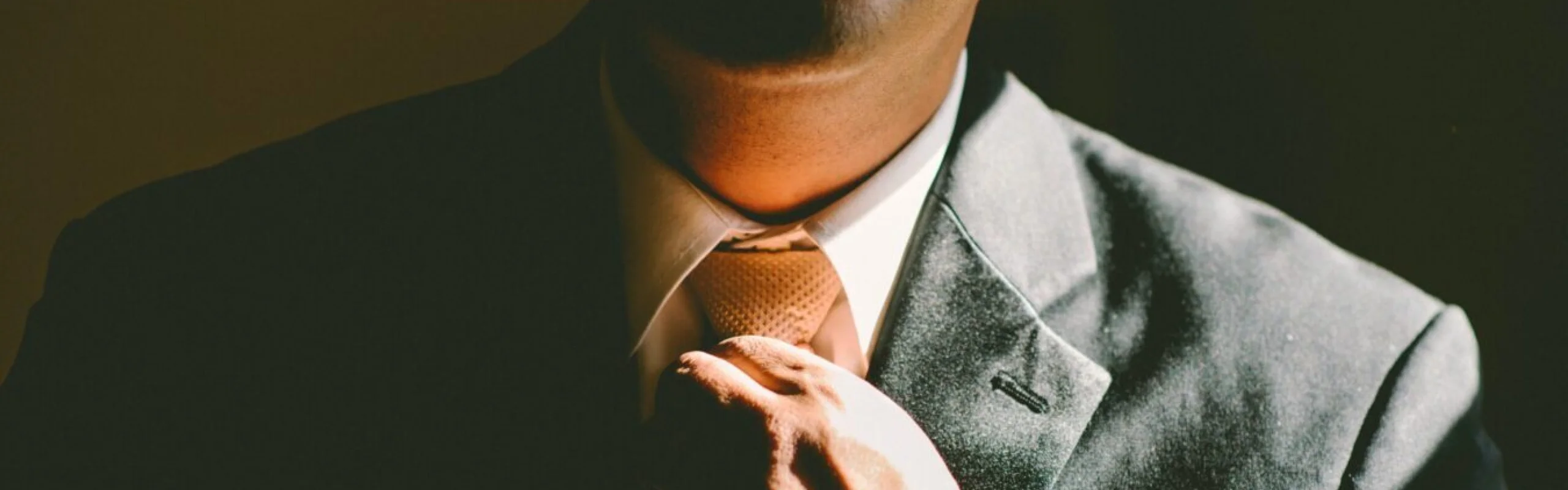 A professional corporate roadshow chauffeur UK driver assisting an executive into a luxury Mercedes-Benz S-Class for a multi-city business itinerary