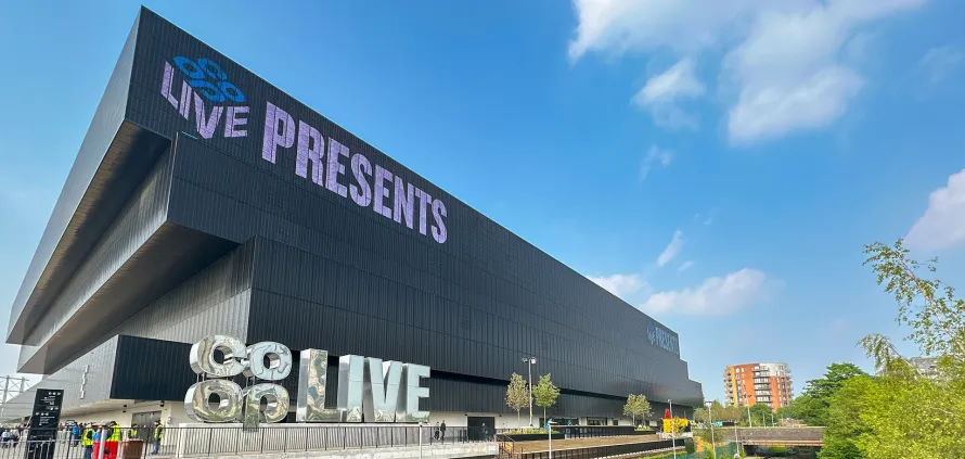 A luxury Mercedes-Benz chauffeur car arriving at the Co-Op Live arena in Manchester for a concert event.